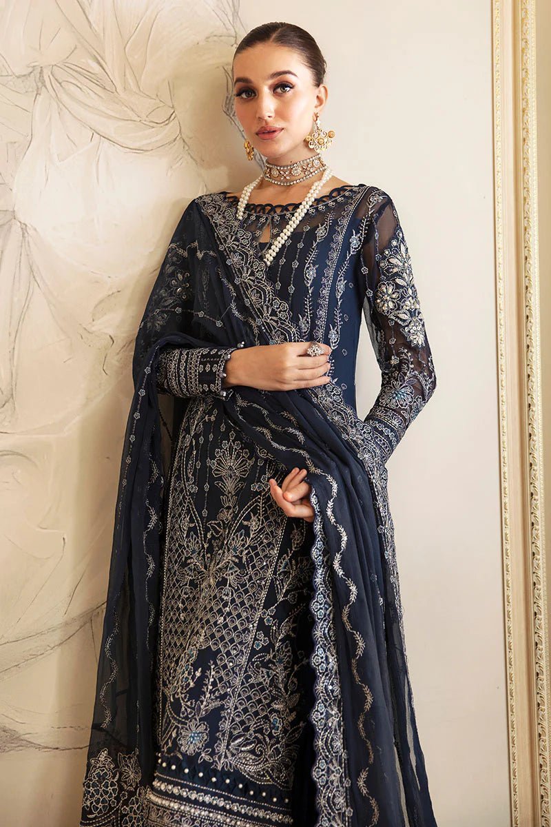 Model wearing Gulaal Embroidered Chiffon 24 Evara dress in navy blue, Pakistani wedding clothes online in UK.