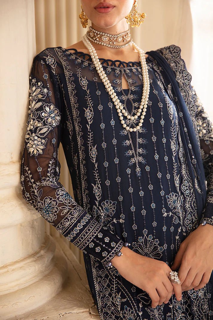 Model wearing Gulaal Embroidered Chiffon 24 Evara dress in navy blue, Pakistani wedding clothes online in UK.