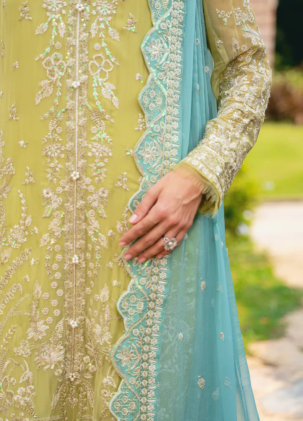 Model wearing Gulaal AMARY dress, a blend of olive and sea green, perfect for Pakistani clothes UK enthusiasts.