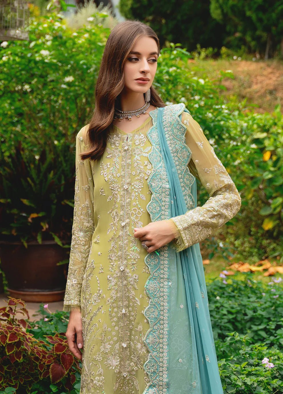 Model wearing Gulaal AMARY dress, a blend of olive and sea green, perfect for Pakistani clothes UK enthusiasts.