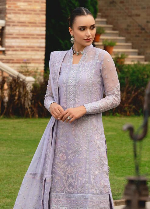 Model wearing Gulaal ARIYA dress, lavender embroidered Pakistani attire UK.