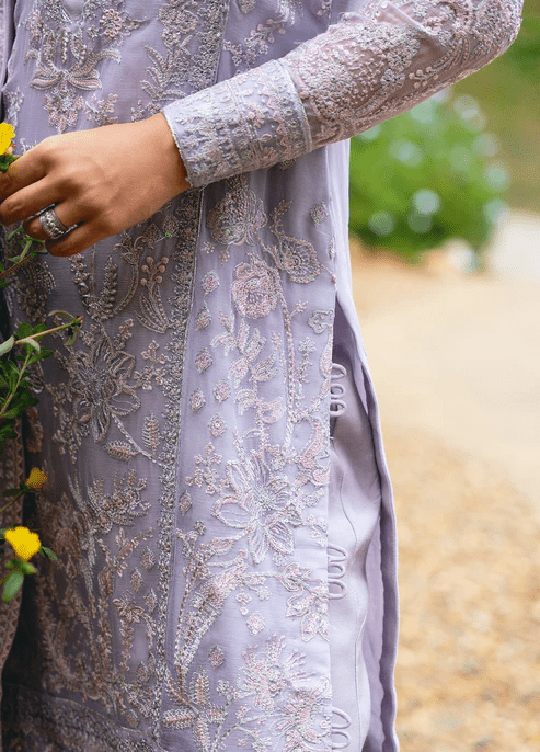 Model wearing Gulaal ARIYA dress, lavender embroidered Pakistani attire UK.