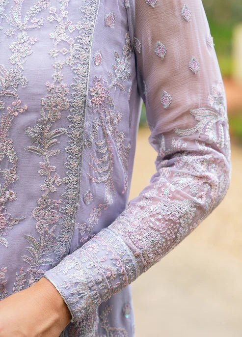 Model wearing Gulaal ARIYA dress, lavender embroidered Pakistani attire UK.