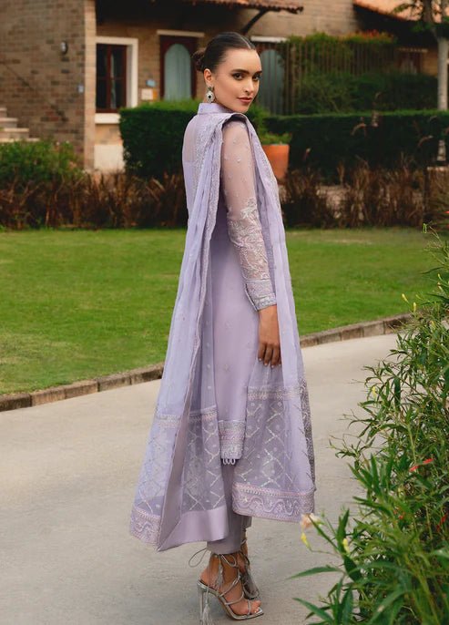 Model wearing Gulaal ARIYA dress, lavender embroidered Pakistani attire UK.