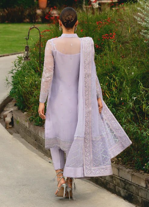 Model wearing Gulaal ARIYA dress, lavender embroidered Pakistani attire UK.