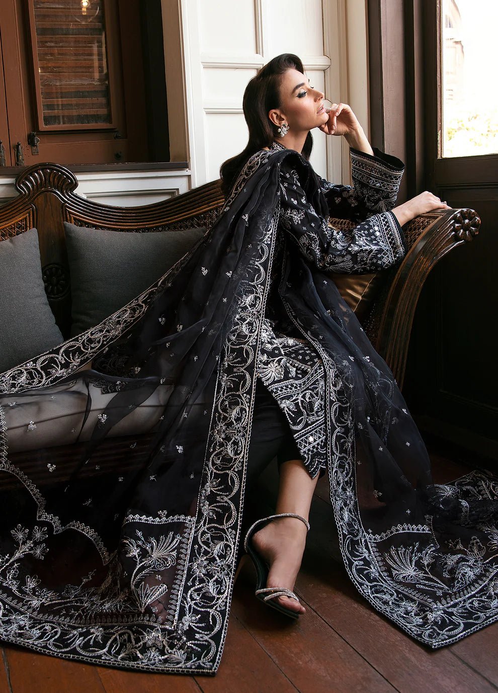 Model wearing the NADINE black and white dress from Gulaal, showcasing luxurious Pakistani clothes online in the UK.