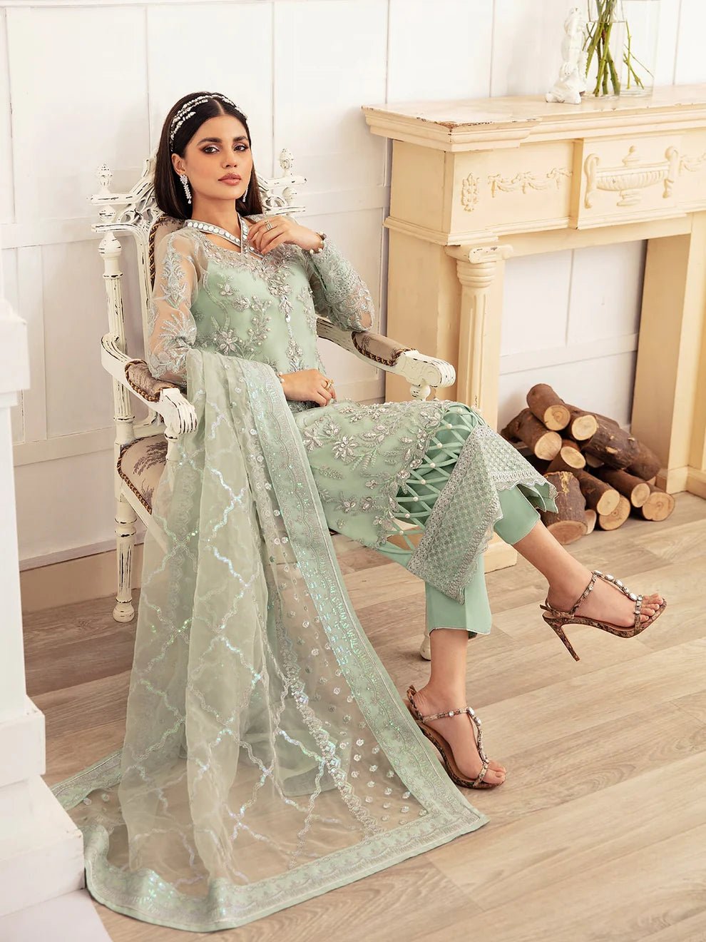 Model wearing a mint green embroidered dress, featuring intricate silver detailing and sheer sleeves from Gulaal. Ideal for showcasing Gulaal's luxury pret collection and Pakistani clothes online in the UK.