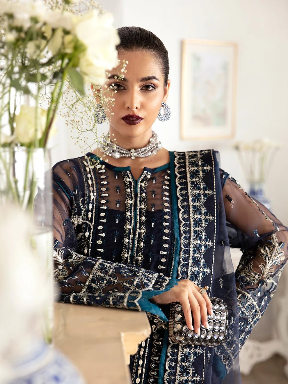 Model wearing a navy blue Sabela GL - LP - V2 - 15 dress from Gulaal. Highlighting intricate embroidery and luxurious design, available in the UK.