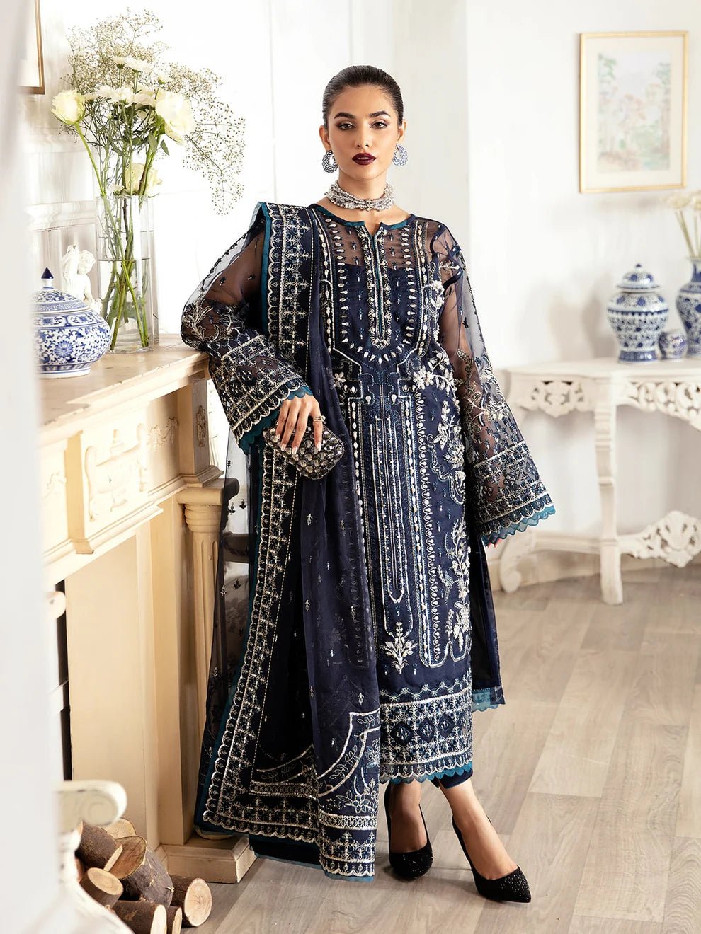 Model wearing a navy blue Sabela GL - LP - V2 - 15 dress from Gulaal. Highlighting intricate embroidery and luxurious design, available in the UK.