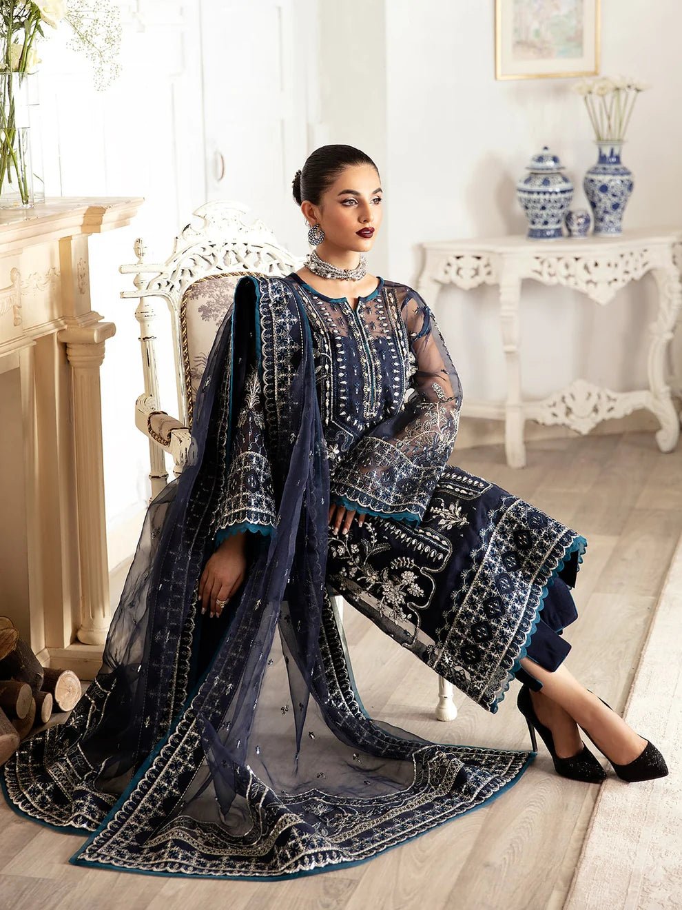 Model wearing a navy blue Sabela GL - LP - V2 - 15 dress from Gulaal. Highlighting intricate embroidery and luxurious design, available in the UK.