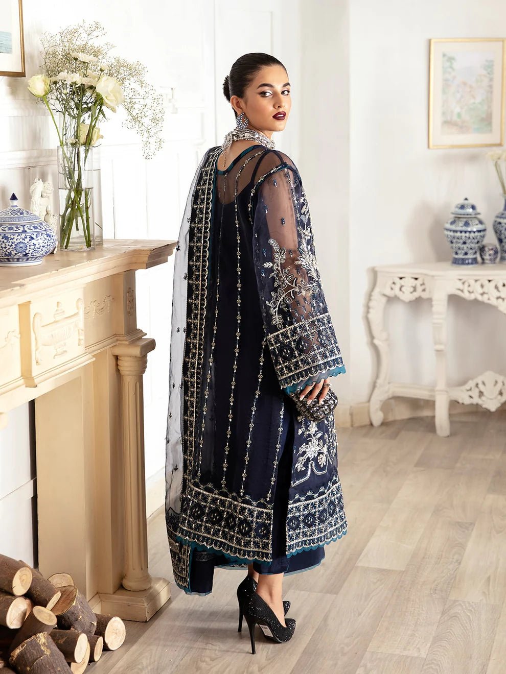 Model wearing a navy blue Sabela GL - LP - V2 - 15 dress from Gulaal. Highlighting intricate embroidery and luxurious design, available in the UK.
