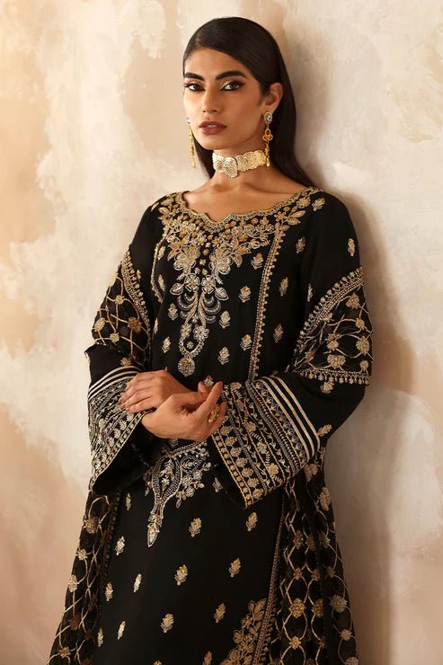 Model wearing a black Gulaal Shehrnaaz Raw Silk outfit with intricate embroidery and sequins, paired with an embroidered chiffon dupatta and dyed silk trousers, perfect for festive occasions.