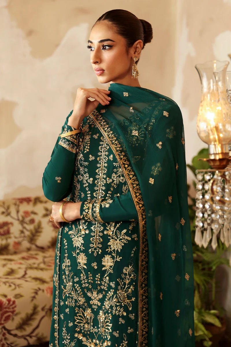 Model in a deep green Gulaal Shehrnaaz Raw Silk outfit with intricate embroidery and sequins, featuring a silk dupatta and matching trousers, perfect for festive occasions. Available online.