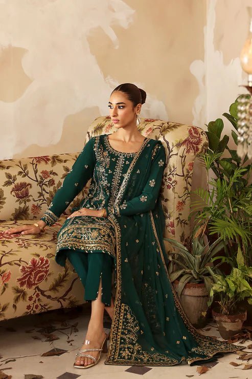 Model in a deep green Gulaal Shehrnaaz Raw Silk outfit with intricate embroidery and sequins, featuring a silk dupatta and matching trousers, perfect for festive occasions. Available online.