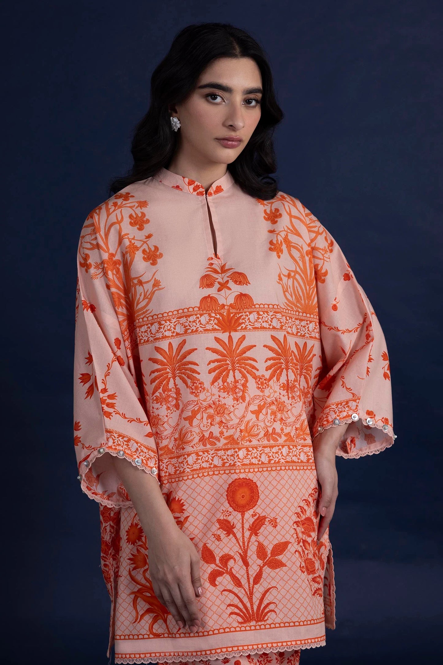 Model wearing peach and orange printed outfit from Sana Safinaz, Mahay Spring '25, ideal for Pakistani clothes online in UK and luxury pret.