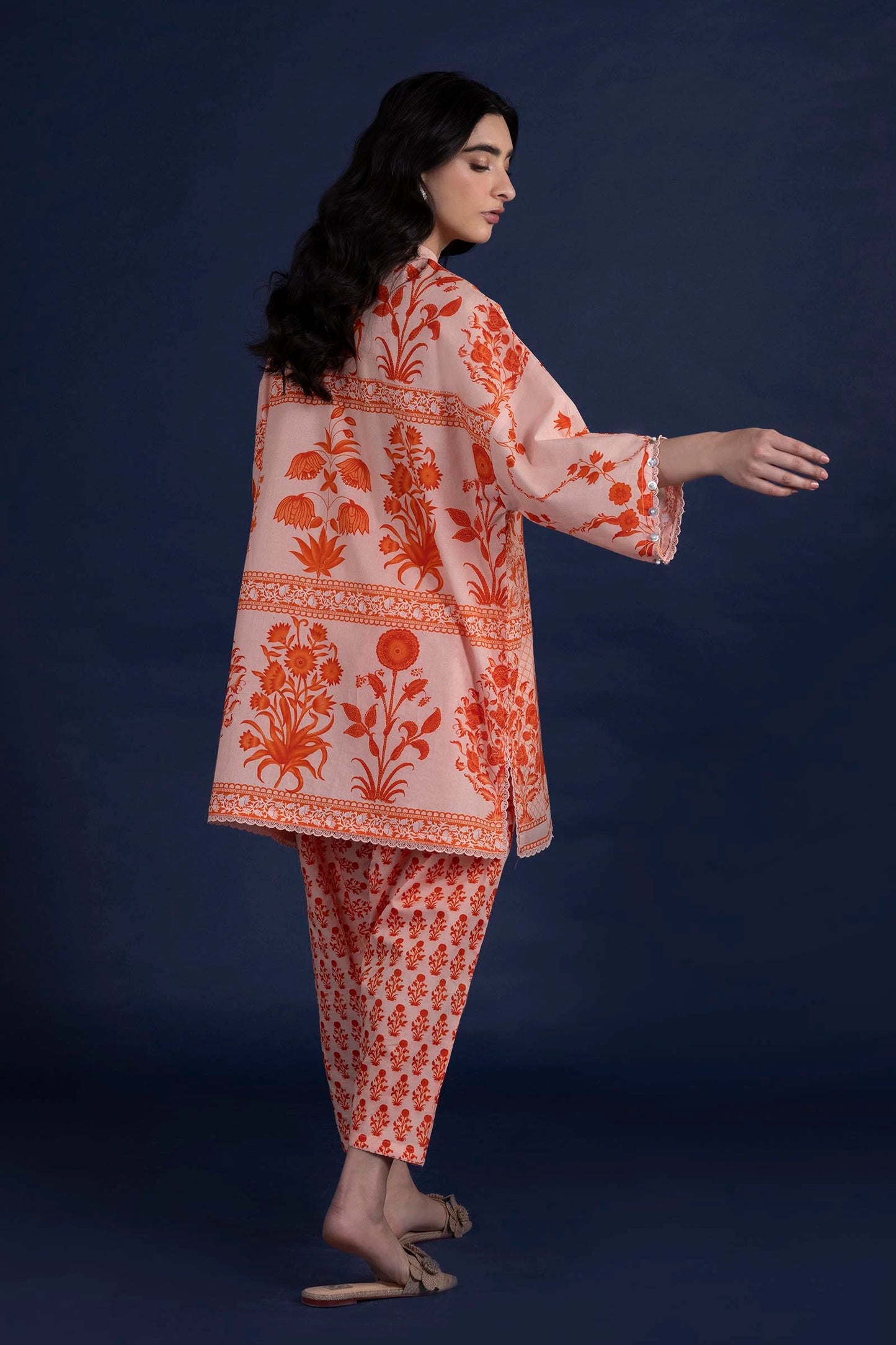 Model wearing peach and orange printed outfit from Sana Safinaz, Mahay Spring '25, ideal for Pakistani clothes online in UK and luxury pret.