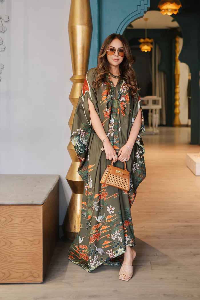 Model wearing olive green kaftan with orange and white floral motifs from Saira Rizwan, Pakistani Luxury pret, Pakistani clothes online in UK.