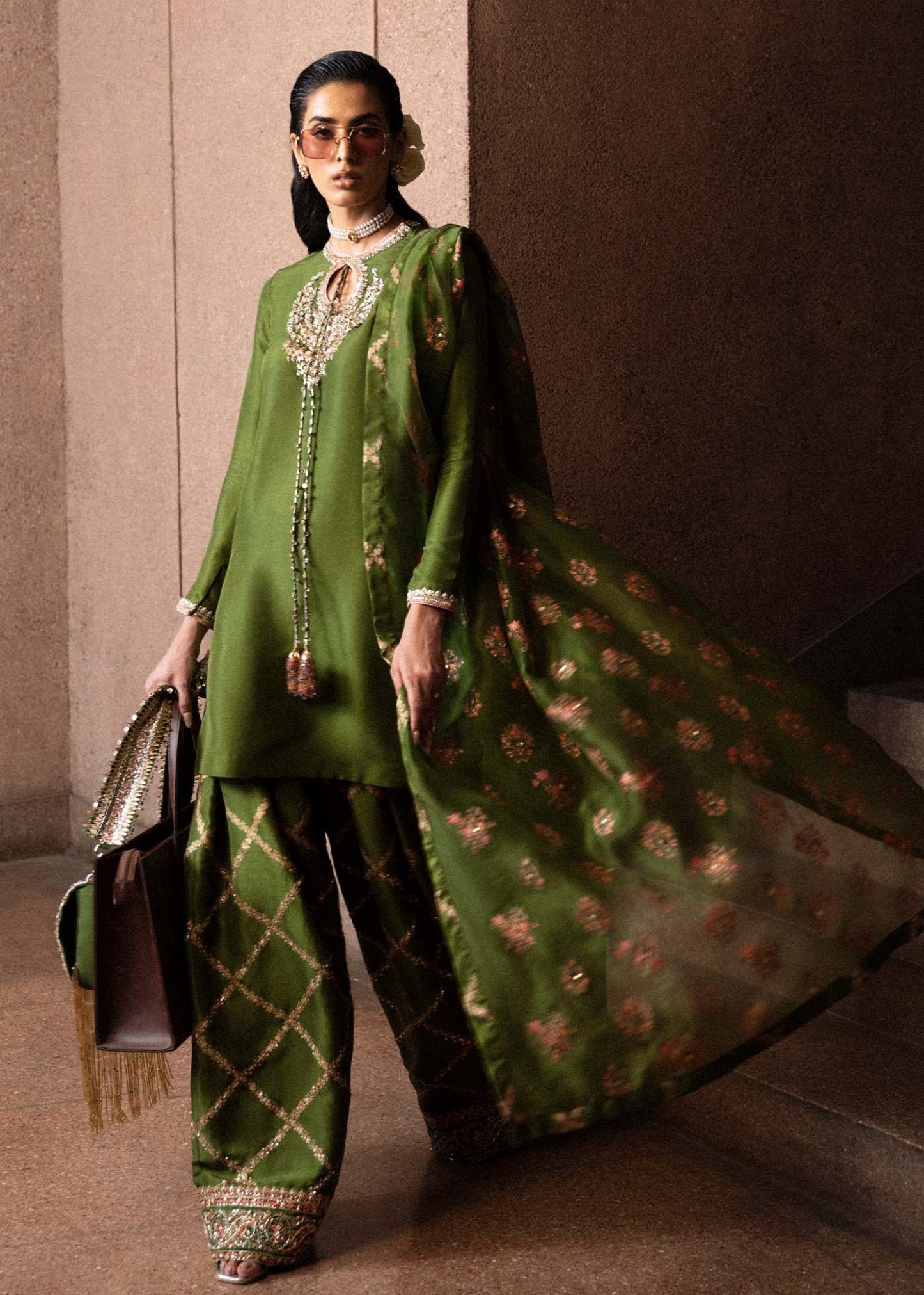 Model wearing an elegant green Celeine dress from Hussain Rehar's Luxury Pret Eid '24 collection. Pakistani clothes online in UK.
