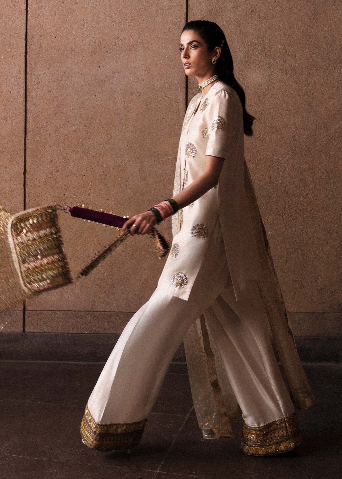 Model wearing an elegant white Lin dress from Hussain Rehar's Luxury Pret Eid '24 collection. Pakistani clothes online in UK.