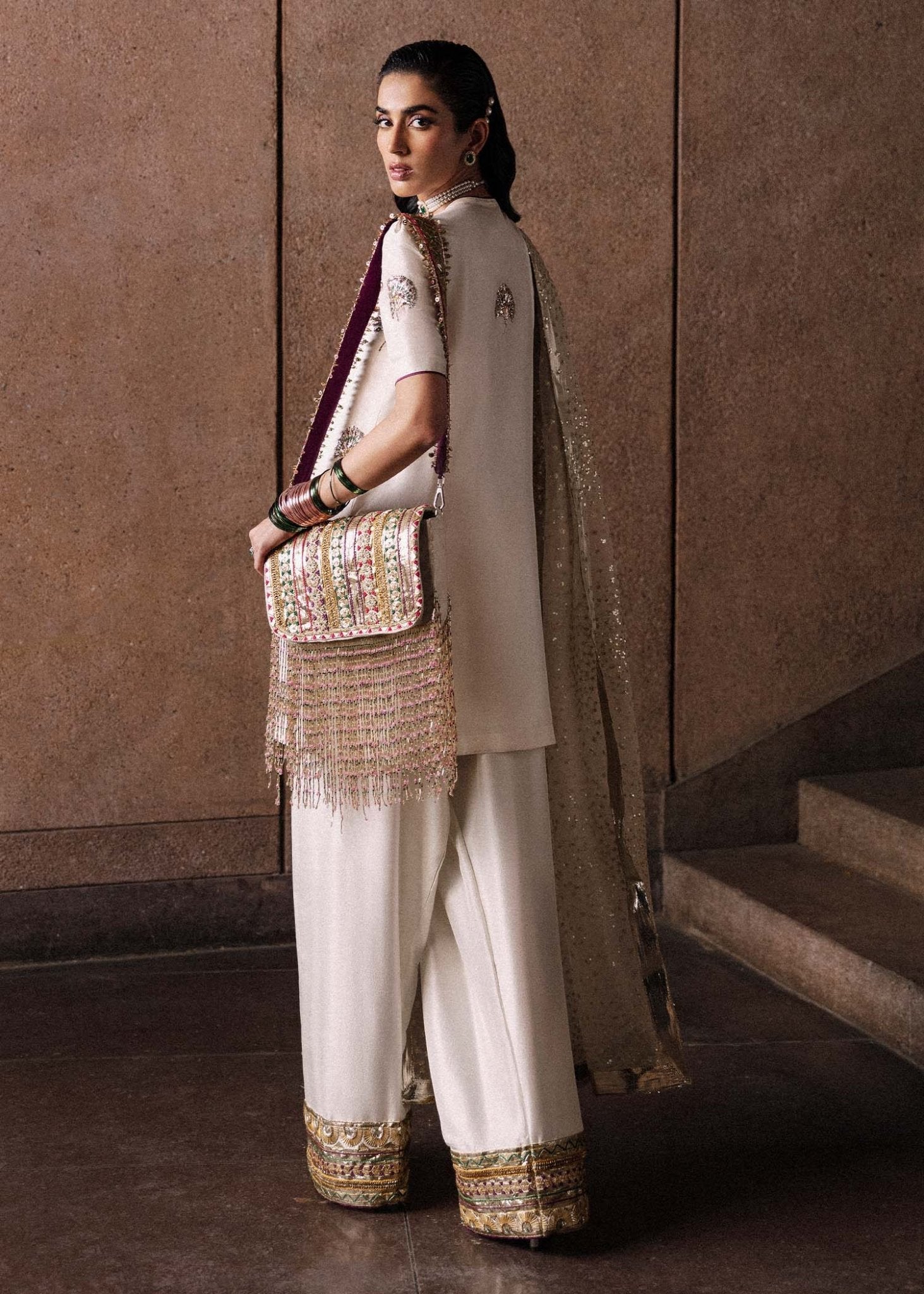 Model wearing an elegant white Lin dress from Hussain Rehar's Luxury Pret Eid '24 collection. Pakistani clothes online in UK.