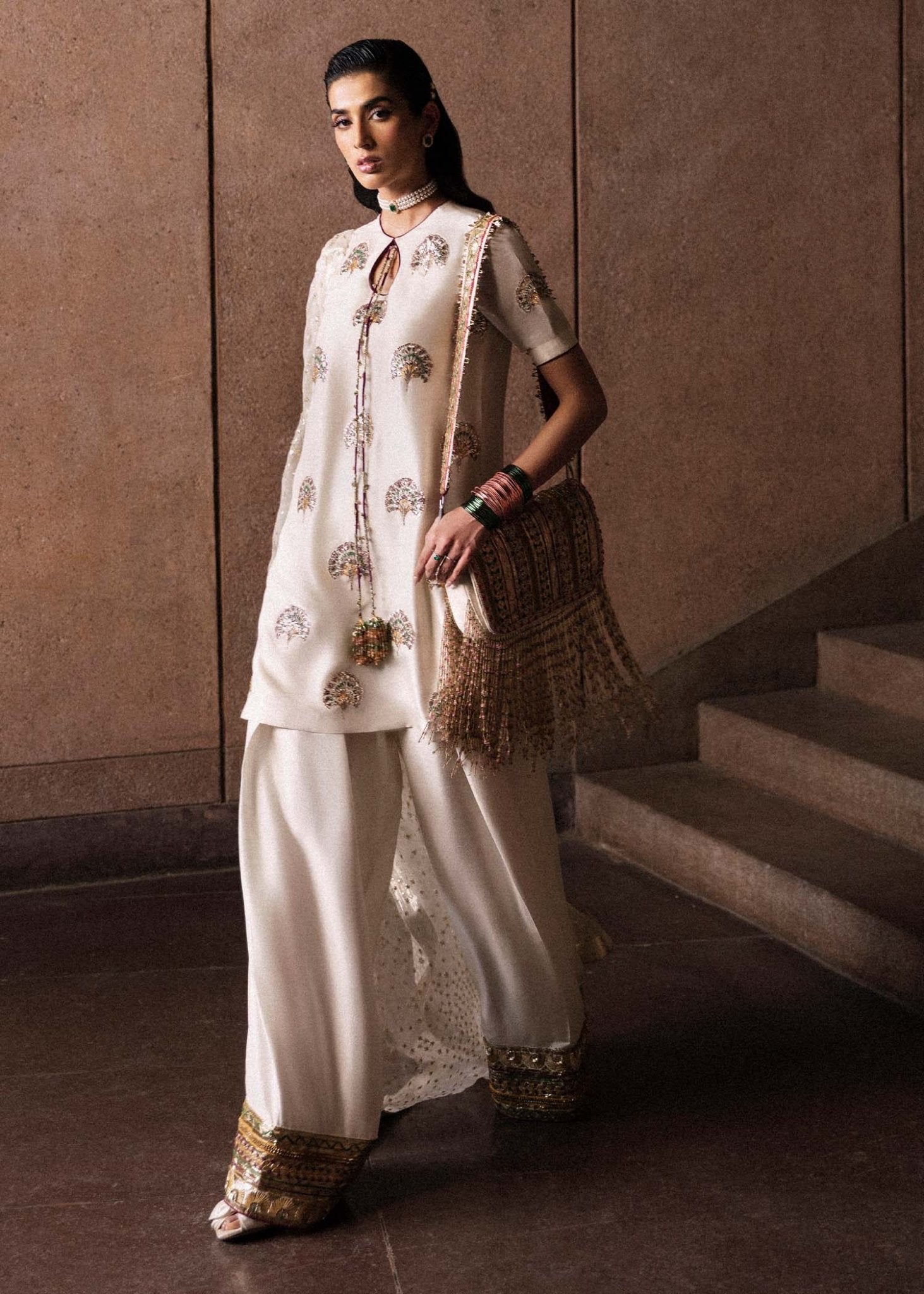 Model wearing an elegant white Lin dress from Hussain Rehar's Luxury Pret Eid '24 collection. Pakistani clothes online in UK.