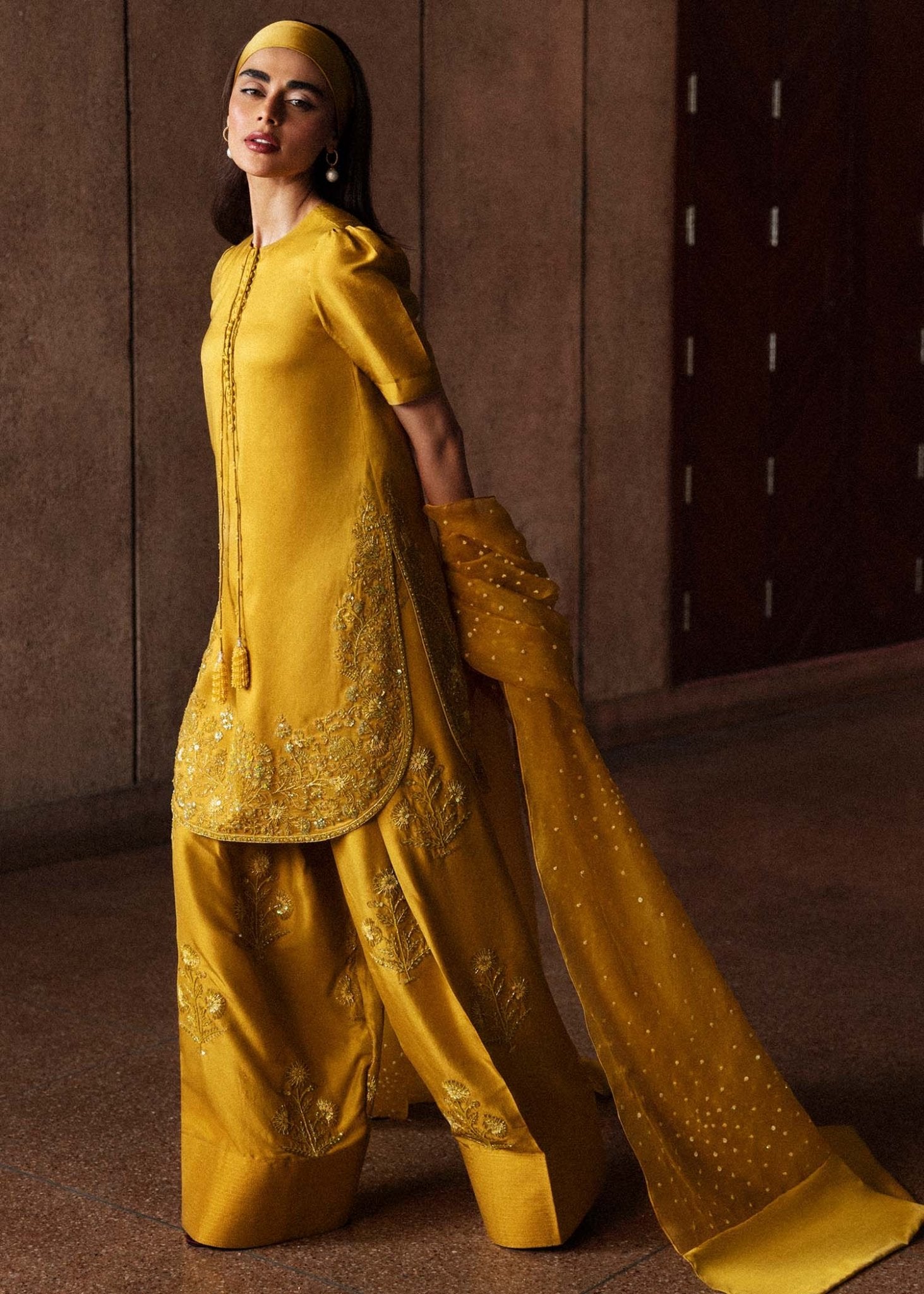 Model wearing a vibrant yellow Maize dress from Hussain Rehar's Luxury Pret Eid '24 collection. Pakistani clothes online in UK.