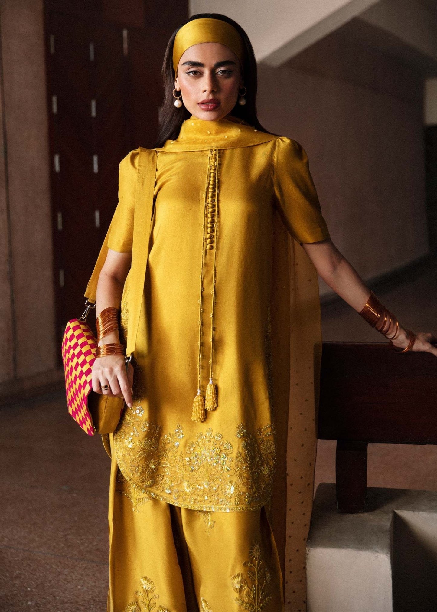 Model wearing a vibrant yellow Maize dress from Hussain Rehar's Luxury Pret Eid '24 collection. Pakistani clothes online in UK.