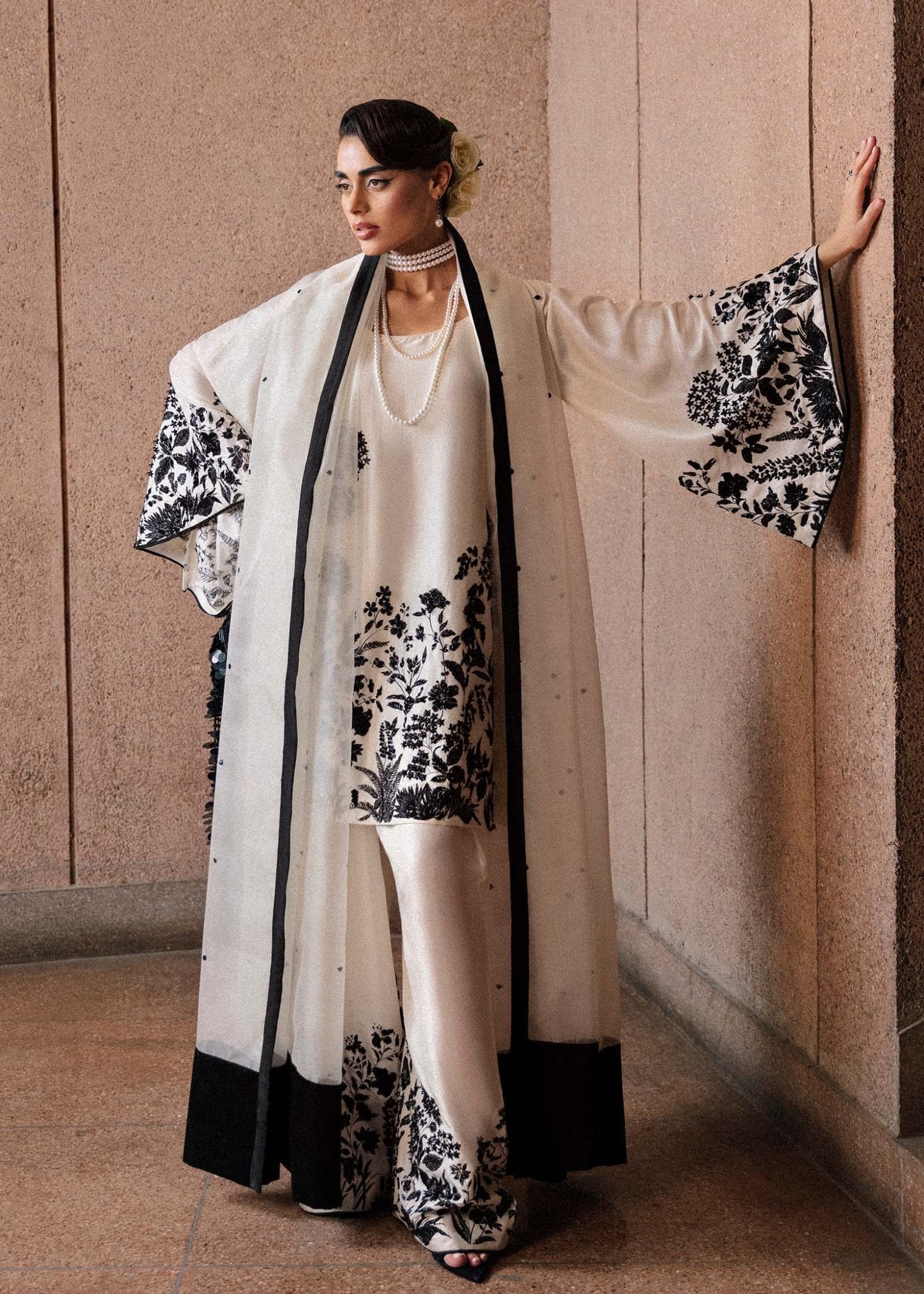Model wearing a black and white Tusk dress from Hussain Rehar's Luxury Pret Eid '24 collection. Pakistani clothes online in UK.