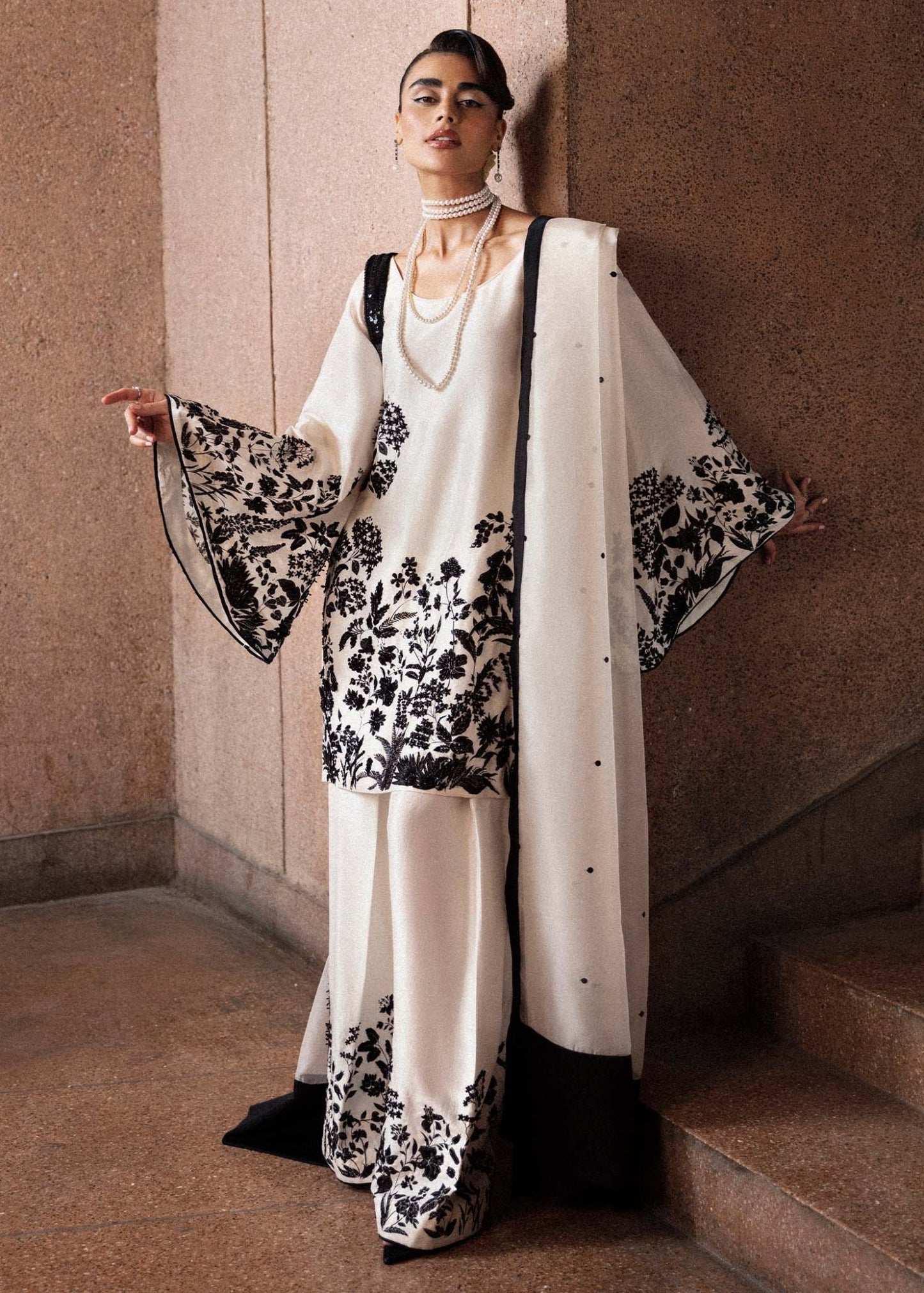 Model wearing a black and white Tusk dress from Hussain Rehar's Luxury Pret Eid '24 collection. Pakistani clothes online in UK.