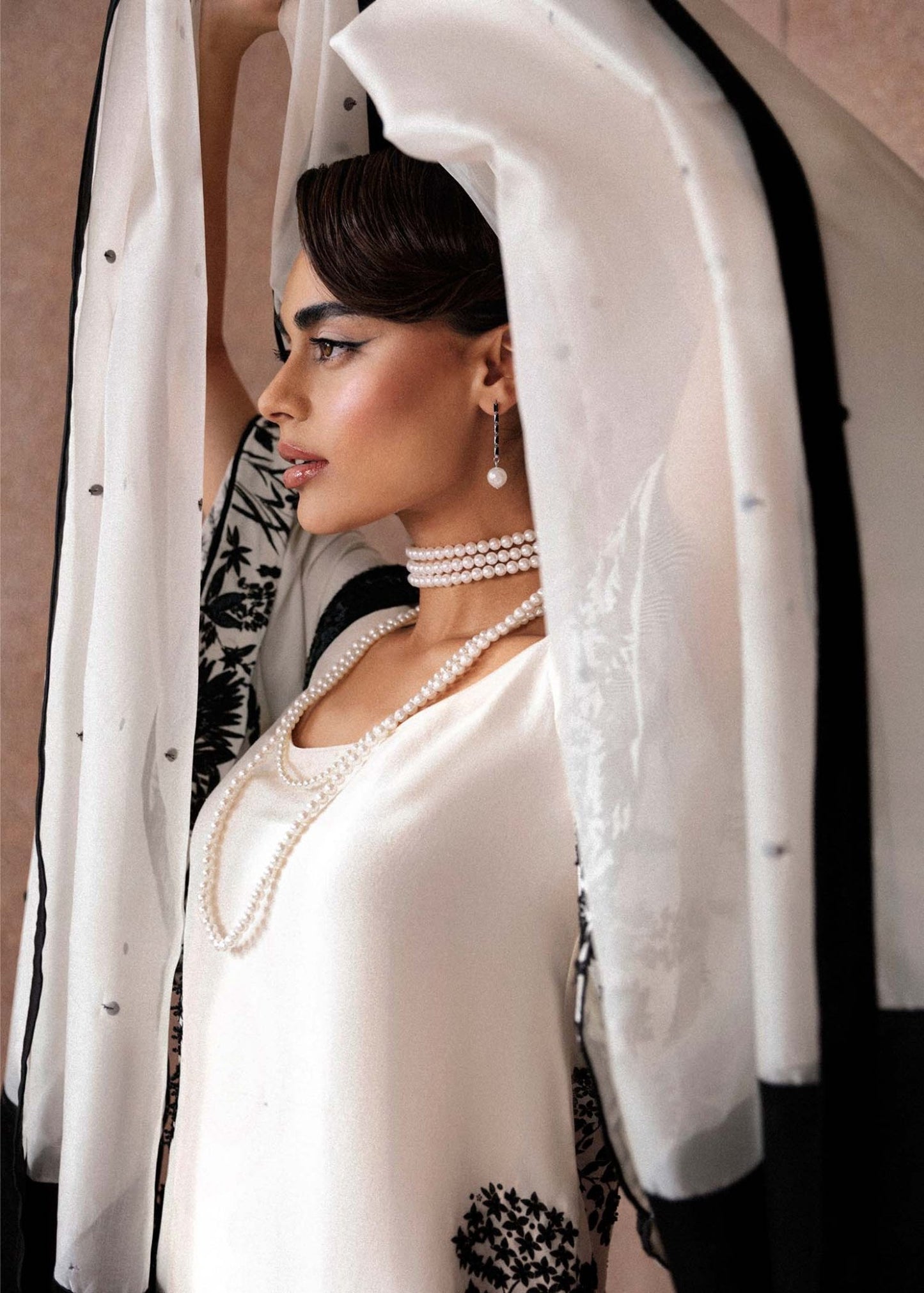 Model wearing a black and white Tusk dress from Hussain Rehar's Luxury Pret Eid '24 collection. Pakistani clothes online in UK.