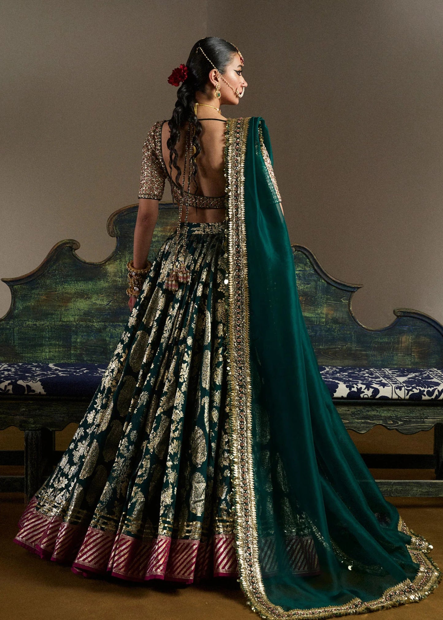 model wearing Neelam green and gold bridal lehenga with embroidered blouse and dupatta from Hussain Rehar, available in the UK. Shop Pakistani bridal dresses online.