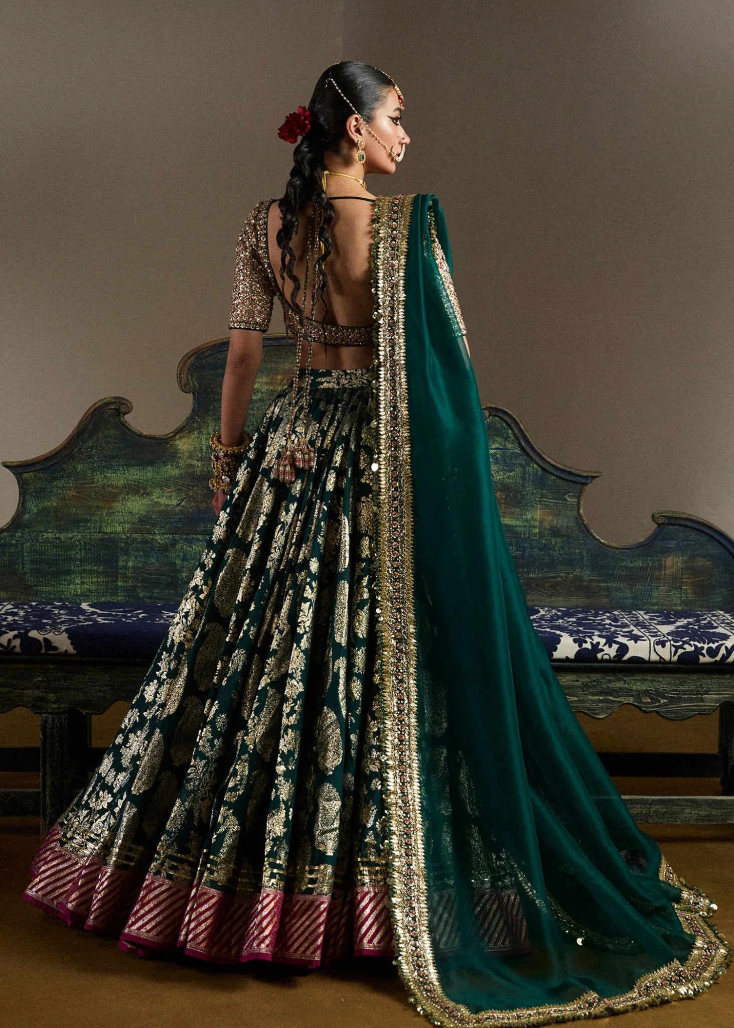 model wearing Neelam green and gold bridal lehenga with embroidered blouse and dupatta from Hussain Rehar, available in the UK. Shop Pakistani bridal dresses online.