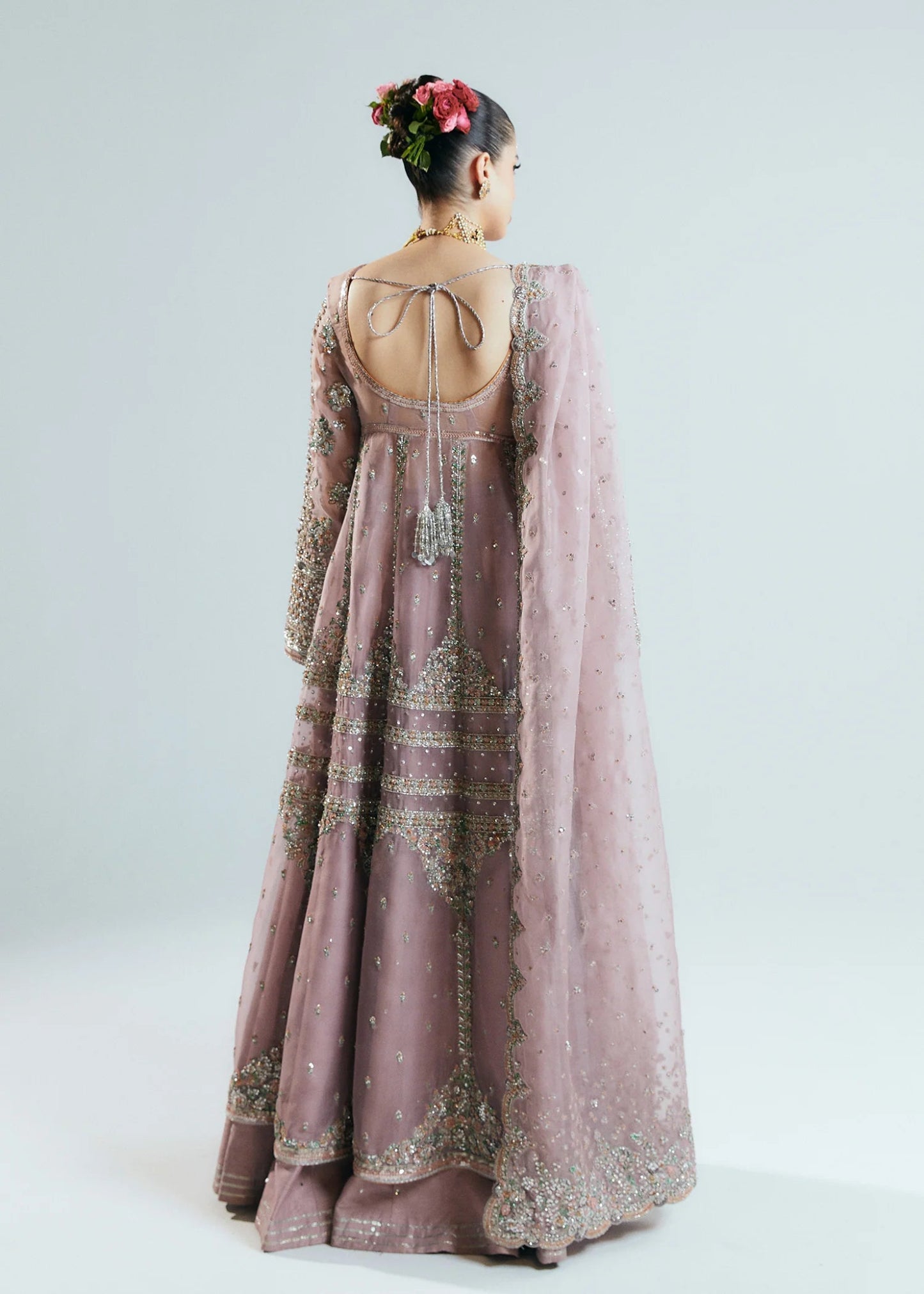 Model wearing a pastel pink Rosabelle dress from Hussain Rehar's Sitaray Formals. Ideal for weddings. Find Pakistani clothes online in UK.