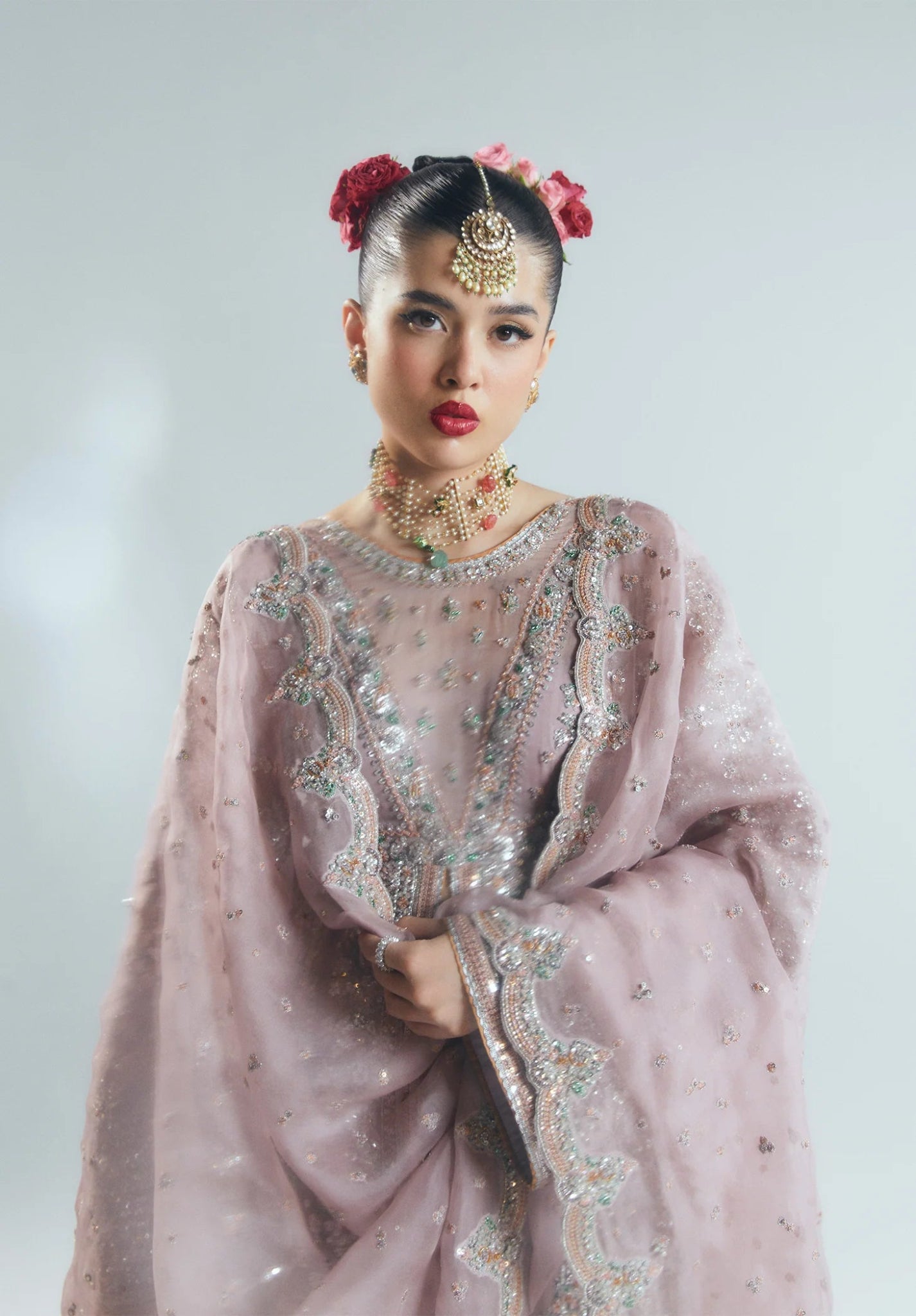 Model wearing a pastel pink Rosabelle dress from Hussain Rehar's Sitaray Formals. Ideal for weddings. Find Pakistani clothes online in UK.