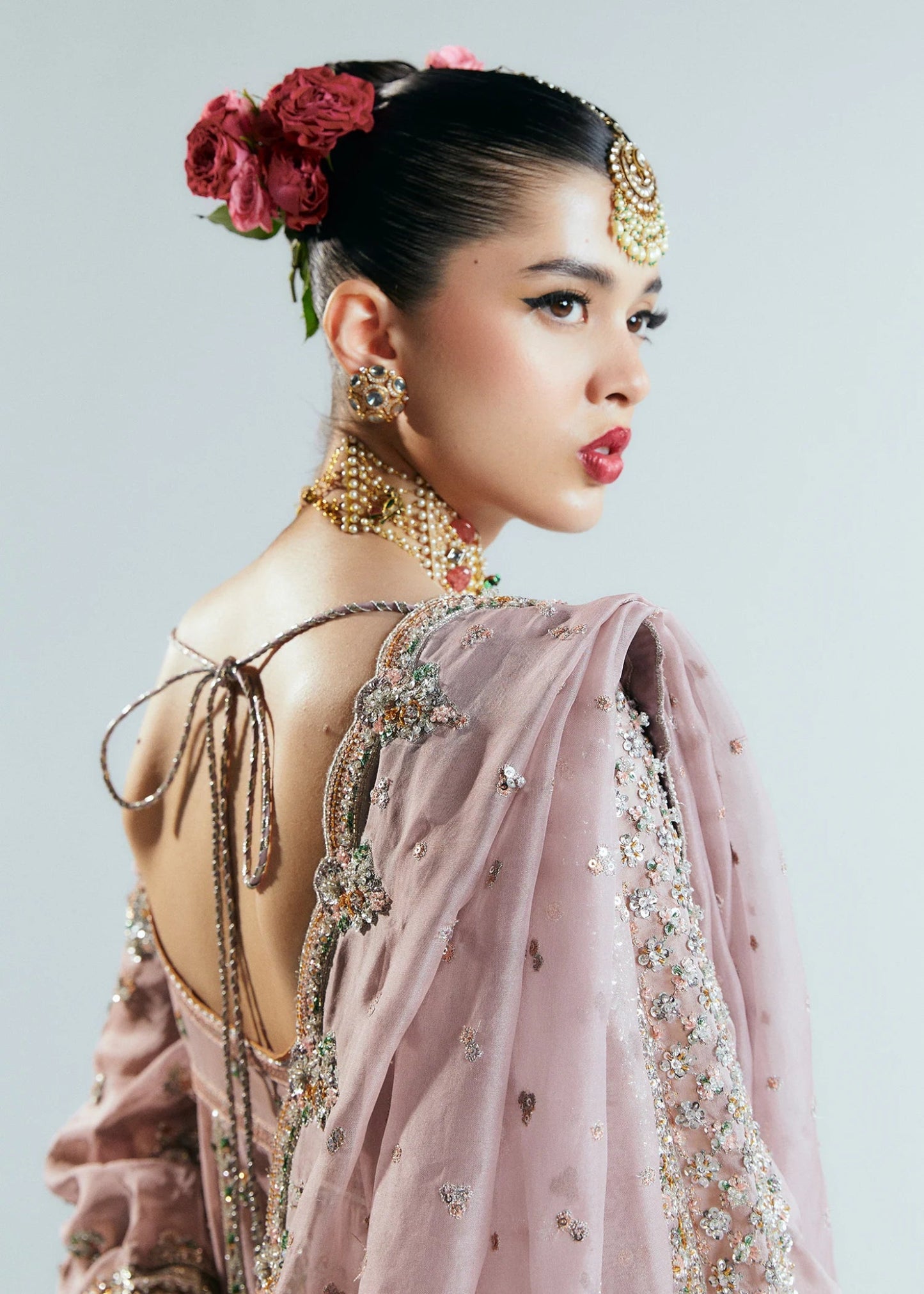 Model wearing a pastel pink Rosabelle dress from Hussain Rehar's Sitaray Formals. Ideal for weddings. Find Pakistani clothes online in UK.