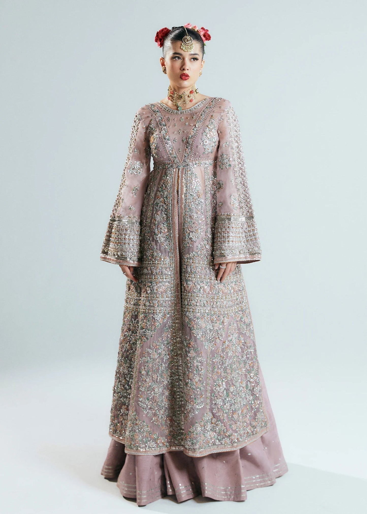 Model wearing a pastel pink Rosabelle dress from Hussain Rehar's Sitaray Formals. Ideal for weddings. Find Pakistani clothes online in UK.