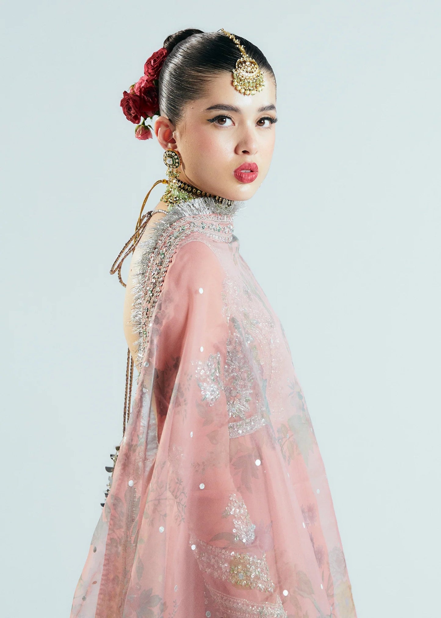Model wearing Hussain Rehar Sitaray Formals Tropica, a peach - colored dress with intricate silver embroidery and embellishments, ideal for weddings.