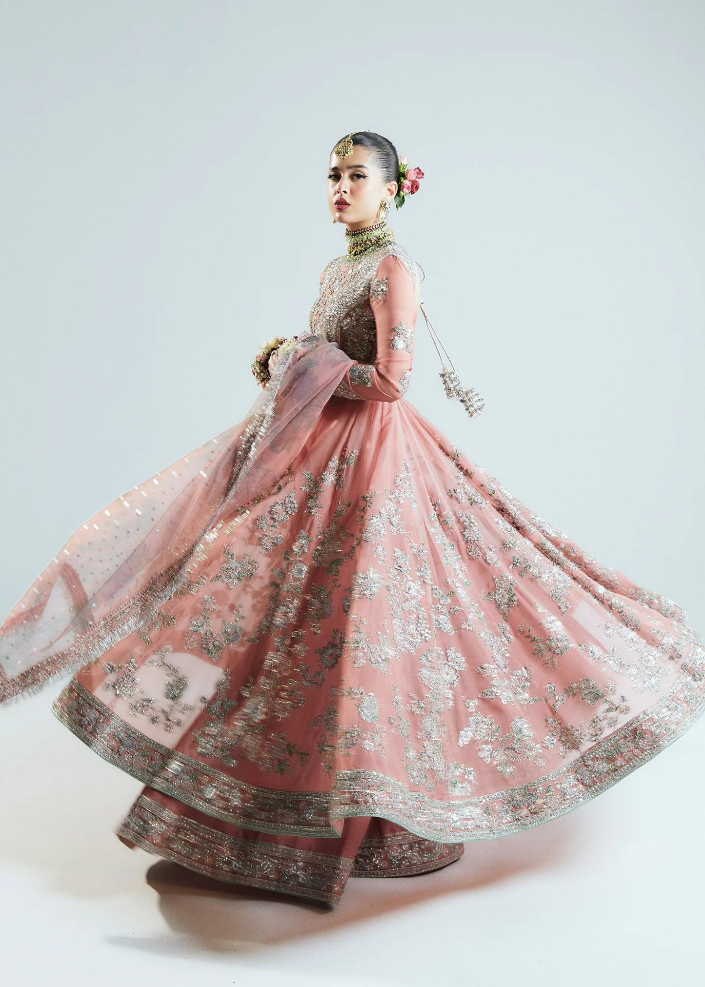 Model wearing Hussain Rehar Sitaray Formals Tropica, a peach - colored dress with intricate silver embroidery and embellishments, ideal for weddings.