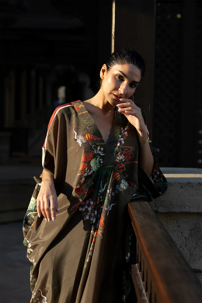 Model wearing olive green kaftan with orange and white floral motifs from Saira Rizwan, Pakistani Luxury pret, Pakistani clothes online in UK.