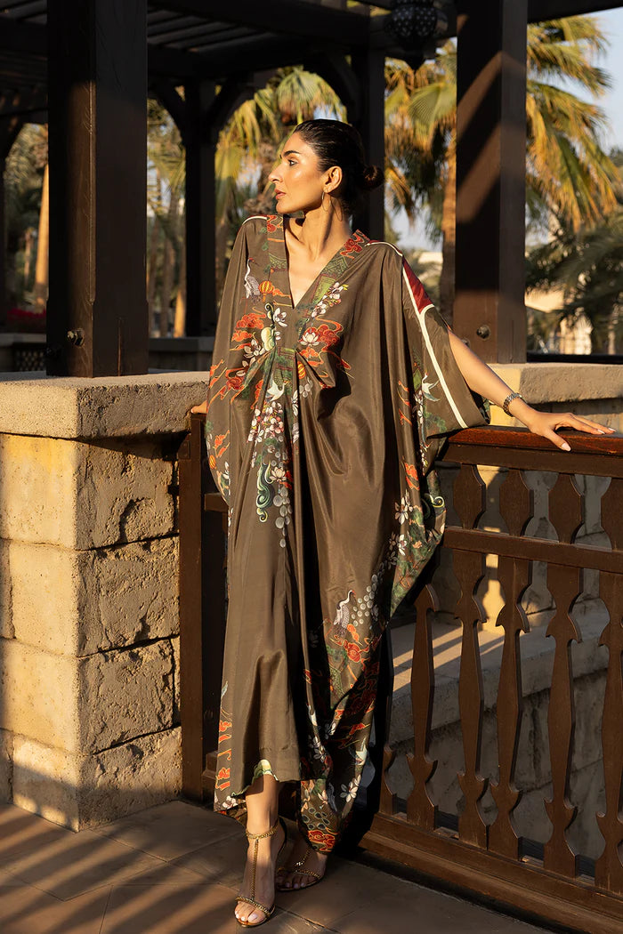 Model wearing olive green kaftan with orange and white floral motifs from Saira Rizwan, Pakistani Luxury pret, Pakistani clothes online in UK.