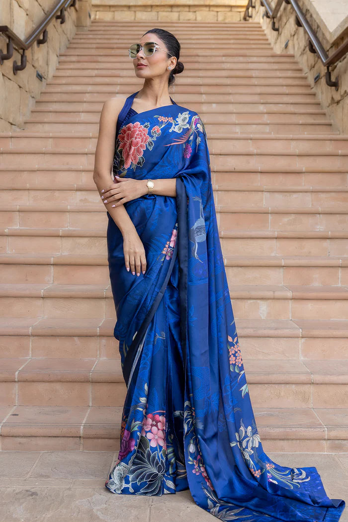 Model wearing royal blue saree with multicolour floral and crane motifs from Saira Rizwan, Pakistani Luxury pret, Pakistani clothes online in UK.