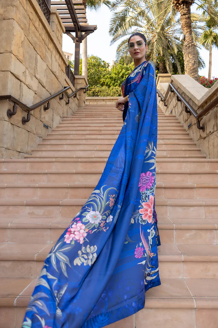Model wearing royal blue saree with multicolour floral and crane motifs from Saira Rizwan, Pakistani Luxury pret, Pakistani clothes online in UK.