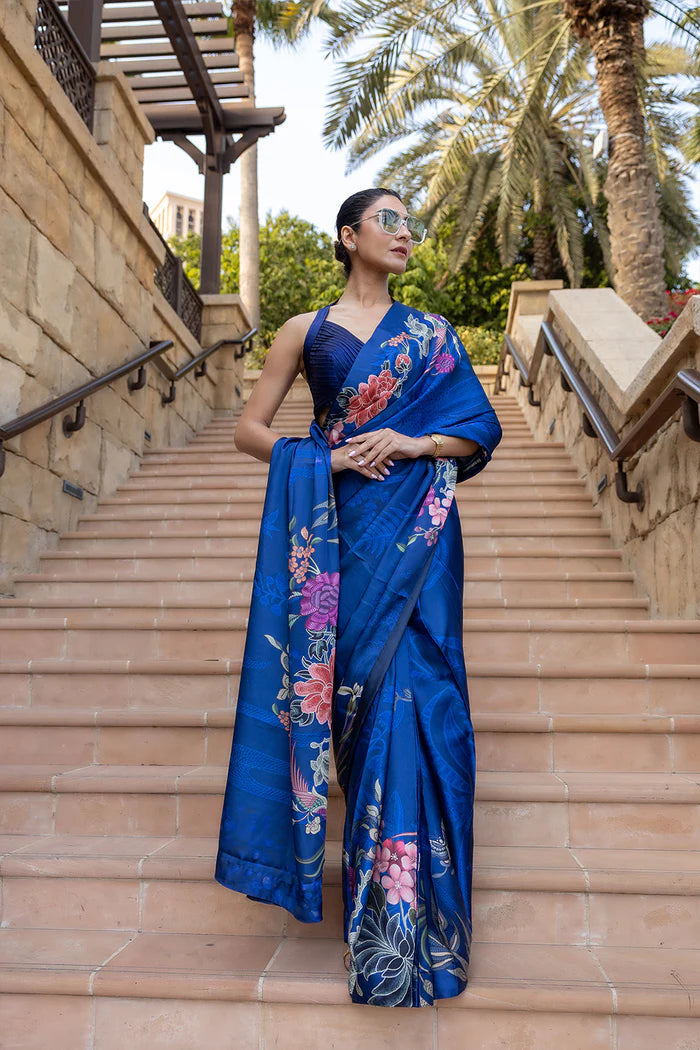 Model wearing royal blue saree with multicolour floral and crane motifs from Saira Rizwan, Pakistani Luxury pret, Pakistani clothes online in UK.