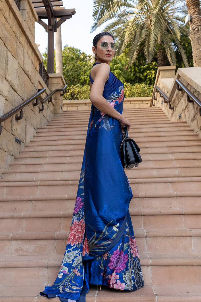 Model wearing royal blue saree with multicolour floral and crane motifs from Saira Rizwan, Pakistani Luxury pret, Pakistani clothes online in UK.