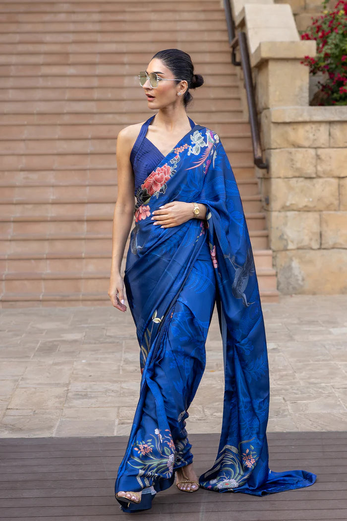 Model wearing royal blue saree with multicolour floral and crane motifs from Saira Rizwan, Pakistani Luxury pret, Pakistani clothes online in UK.