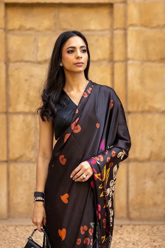 Model wearing black saree with multicolour heart and floral motifs from Saira Rizwan, Pakistani Luxury pret, Pakistani clothes online in UK.