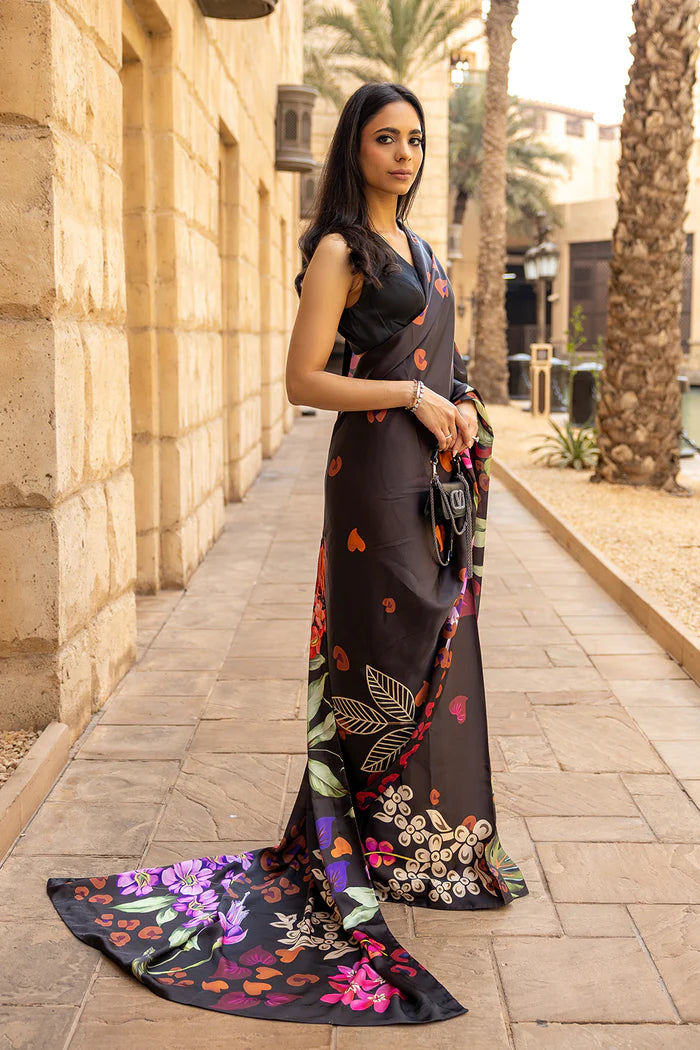 Model wearing black saree with multicolour heart and floral motifs from Saira Rizwan, Pakistani Luxury pret, Pakistani clothes online in UK.