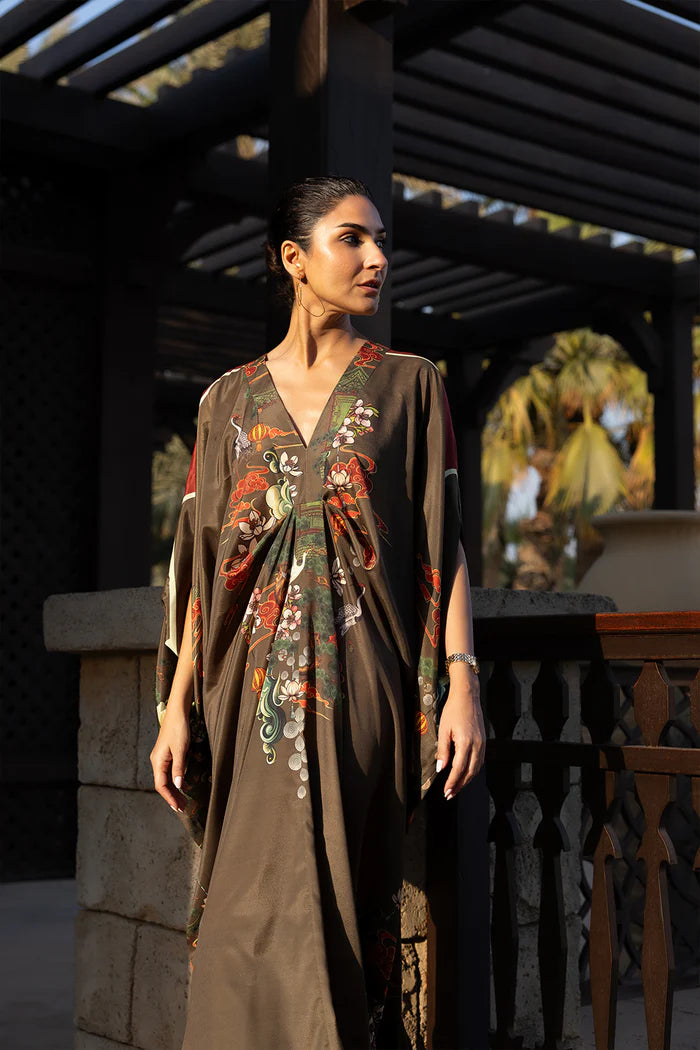 Model wearing olive green kaftan with orange and white floral motifs from Saira Rizwan, Pakistani Luxury pret, Pakistani clothes online in UK.