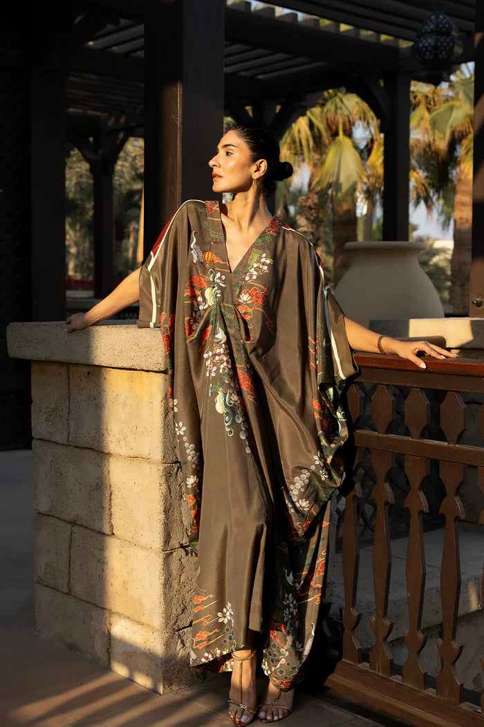 Model wearing olive green kaftan with orange and white floral motifs from Saira Rizwan, Pakistani Luxury pret, Pakistani clothes online in UK.