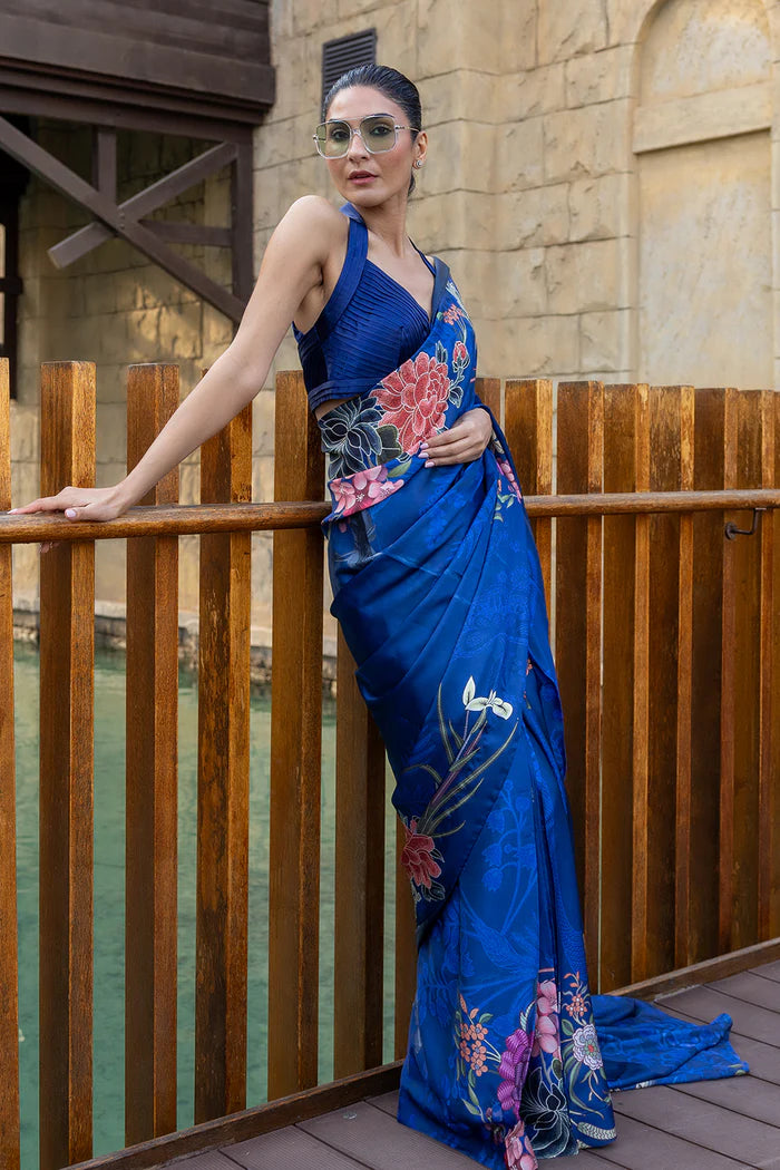 Model wearing royal blue saree with multicolour floral and crane motifs from Saira Rizwan, Pakistani Luxury pret, Pakistani clothes online in UK.
